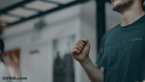 A Man Wearing A Black T-Shirt With The Word Pierre Cardin Written On It GIF