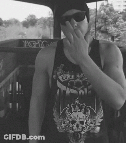 A Man Wearing A Black Tank Top That Says Driven To Be GIF