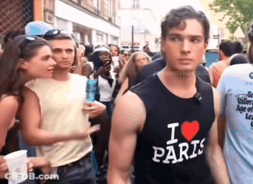A Man Wearing A Black Tank Top That Says " I Love Paris " GIF
