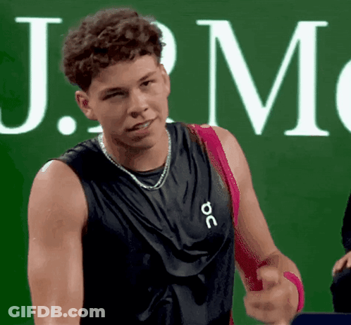 A Man Wearing A Black Tank Top That Says J.m. GIF