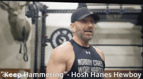 A Man Wearing A Black Tank Top That Says Nobody Cares Work Harder GIF