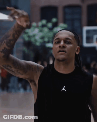 A Man Wearing A Black Tank Top With The Letter J On The Front GIF