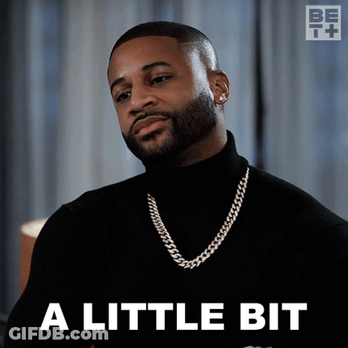A Man Wearing A Black Turtleneck And A Gold Chain Says A Little Bit GIF