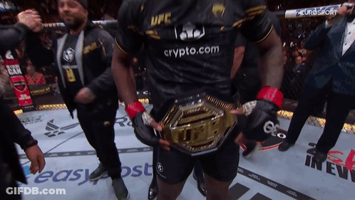 A Man Wearing A Black Ufc Shirt Holds A Gold Belt GIF