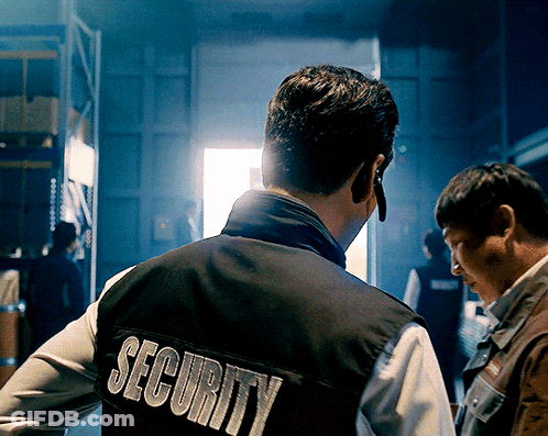 A Man Wearing A Black Vest That Says Security On It GIF