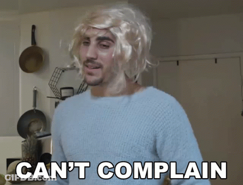 A Man Wearing A Blonde Wig And A Blue Sweater Says " Can 'T Complain " GIF