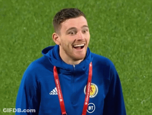 A Man Wearing A Blue Adidas Jacket Is Smiling On A Field GIF
