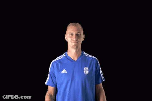 A Man Wearing A Blue Adidas Shirt Is Giving A Thumbs Up GIF