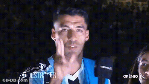 A Man Wearing A Blue And Black Jersey Is Giving The Middle Finger GIF