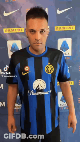 A Man Wearing A Blue And Black Striped Soccer Jersey With Paramount On It . GIF