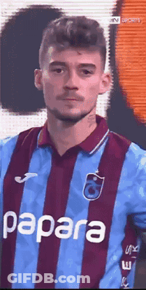 A Man Wearing A Blue And Purple Striped Shirt With Papara On It GIF