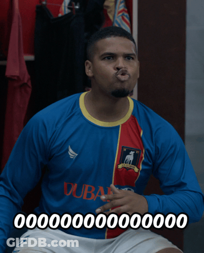 A Man Wearing A Blue And Red Dubai Jersey Making A Funny Face GIF