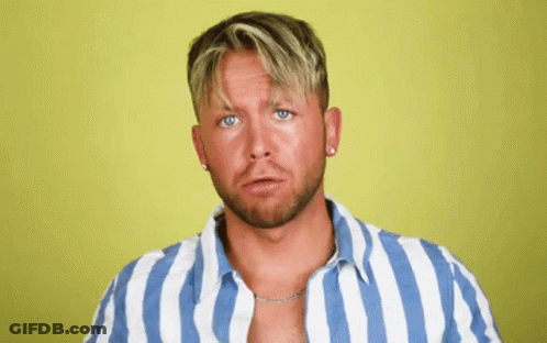 A Man Wearing A Blue And White Striped Shirt Looks At The Camera GIF