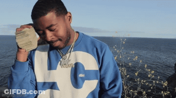 A Man Wearing A Blue And White Sweatshirt With The Letter L On It GIF