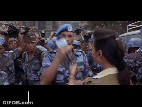 A Man Wearing A Blue Beret With The Number 10 On It GIF