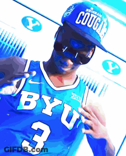 A Man Wearing A Blue Byu Jersey And A Blue Cougars Hat GIF