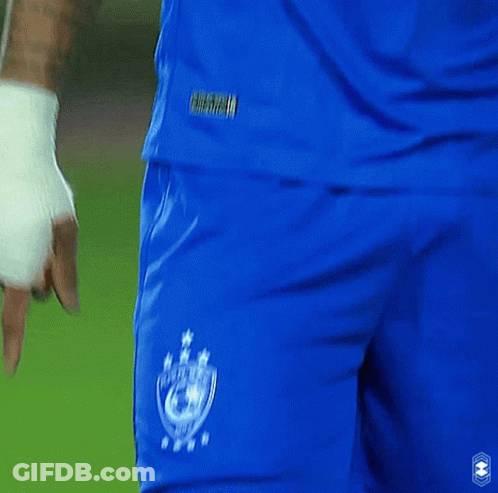 A Man Wearing A Blue Emaar Jersey Looks To His Left GIF