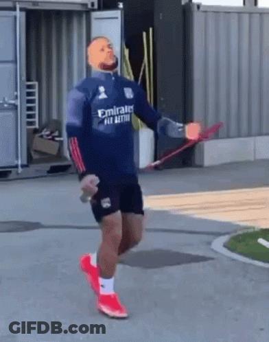 A Man Wearing A Blue Emirates Shirt Is Jumping A Rope GIF