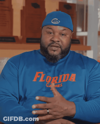 A Man Wearing A Blue Florida Gators Shirt Talks GIF