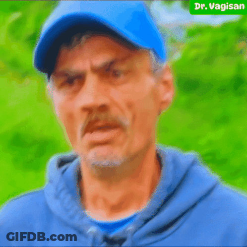 Man In Blue Hat And Hoodie Looks Angry GIF