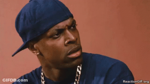 A Man Wearing A Blue Hat And A Gold Chain Is Rubbing His Nose . GIF