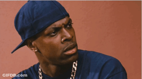 A Man Wearing A Blue Hat And A Gold Chain Is Smoking A Cigarette GIF
