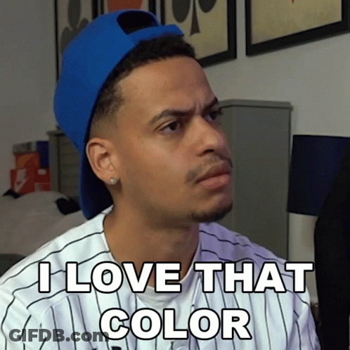 A Man Wearing A Blue Hat And A Striped Shirt Says " I Love That Color " GIF