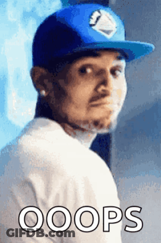 A Man Wearing A Blue Hat And A White Shirt Has The Word Oops Written Below Him GIF