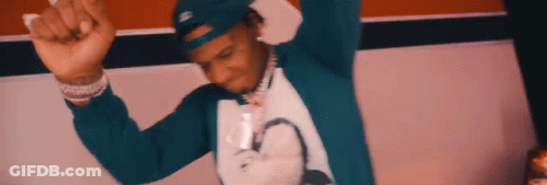A Man Wearing A Blue Hat And A White Shirt Is Dancing . GIF