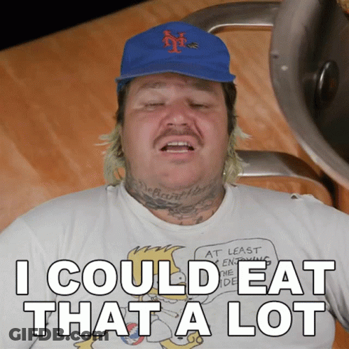 A Man Wearing A Blue Hat And A White Shirt That Says I Could Eat That A Lot GIF