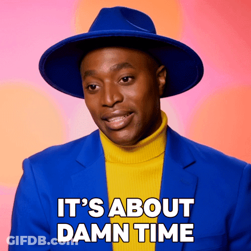 A Man Wearing A Blue Hat And A Yellow Turtleneck Sweater Says " It 'S About Damn Time " GIF