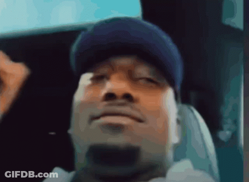 A Man Wearing A Blue Hat Is Sitting In A Chair GIF
