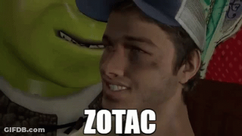 A Man Wearing A Blue Hat Is Smiling Next To Shrek And The Word Zotac Is On His Face GIF