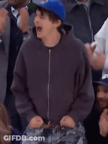 A Man Wearing A Blue Hat That Says Oklahoma On It GIF