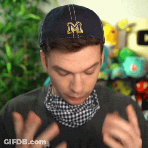 A Man Wearing A Blue Hat With A Letter M On It GIF