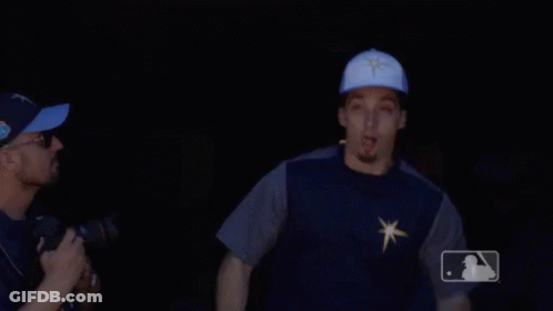 A Man Wearing A Blue Hat With A Star On It Is Pointing GIF
