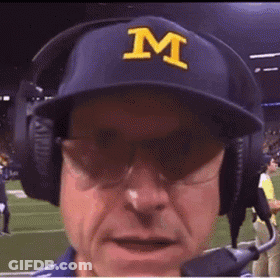 A Man Wearing A Blue Hat With A Yellow Letter M On It GIF