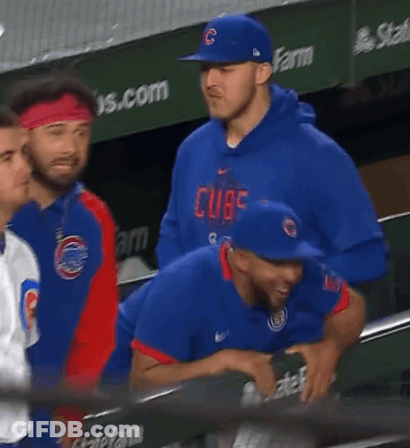 A Man Wearing A Blue Hat With The Letter C On It Stands In A Dugout GIF