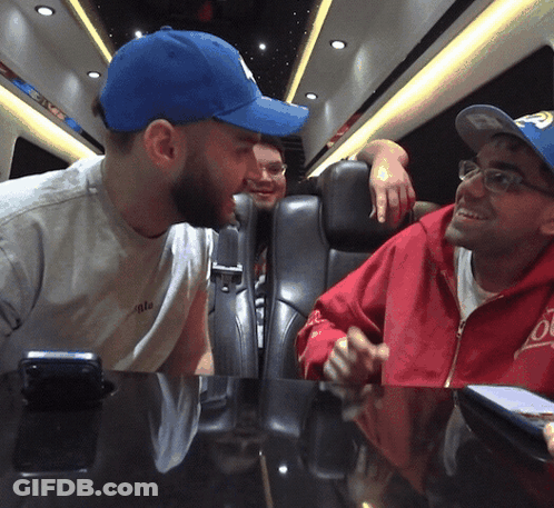 A Man Wearing A Blue Hat With The Letter P On It Talks To Another Man GIF
