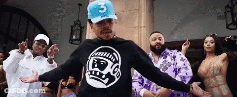 A Man Wearing A Blue Hat With The Number 3 On It Is Dancing With A Group Of People GIF
