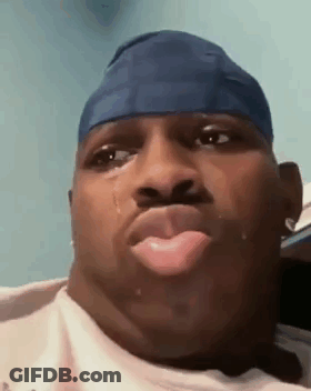 A Man Wearing A Blue Headband Is Crying With A Tear Coming Out Of His Nose . GIF