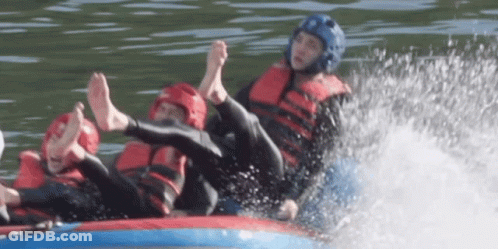 A Man Wearing A Blue Helmet Is Laying On A Raft In The Water GIF