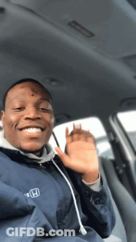 A Man Wearing A Blue Honda Jacket Is Smiling And Waving GIF