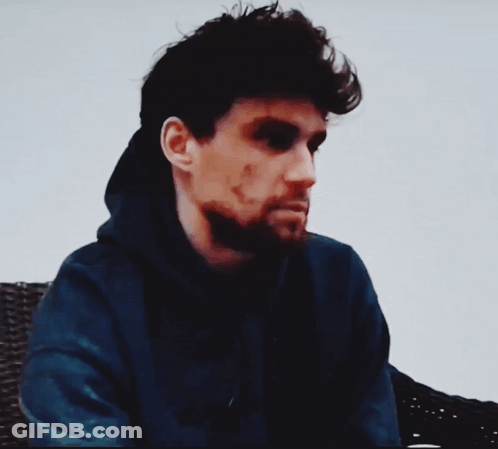 A Man Wearing A Blue Hoodie With The Words " You Need A Warm Glass Of Shut The Hell Up " Below Him GIF