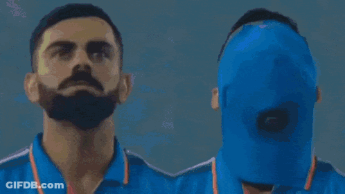 A Man Wearing A Blue India Shirt Looks Up At The Sky GIF