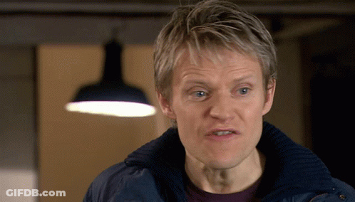 A Man Wearing A Blue Jacket Looks At The Camera GIF