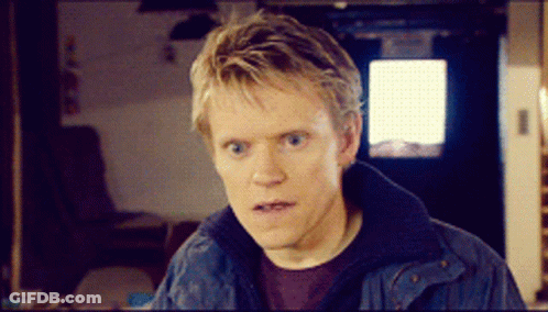 A Man Wearing A Blue Jacket Looks At The Camera GIF