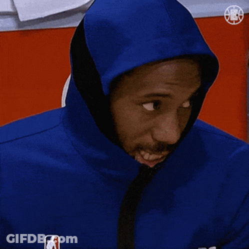A Man Wearing A Blue Jacket With A Hood On His Head Looks At The Camera GIF