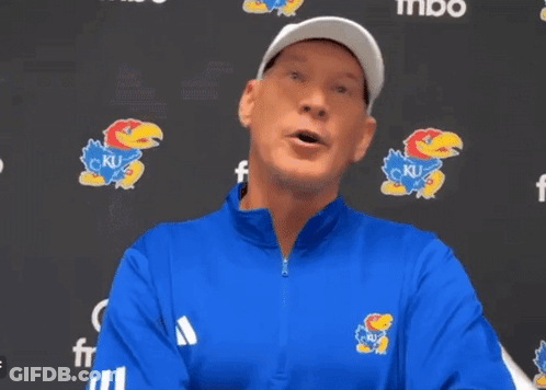 A Man Wearing A Blue Jacket With A Ku Logo On The Front GIF