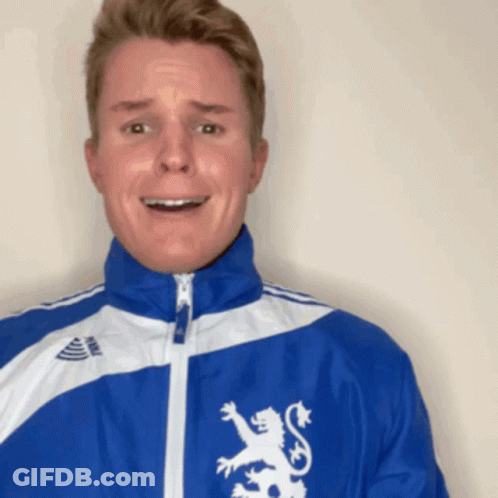 A Man Wearing A Blue Jacket With A Lion On It GIF